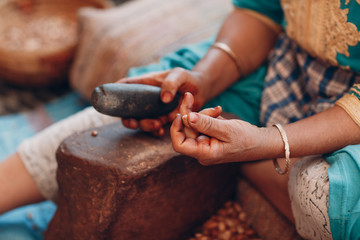 Woman making argan oil by hand craft