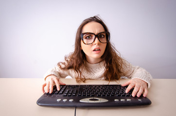 Funny nerd girl working on computer
