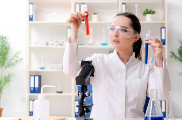 Young female chemist working in the lab 