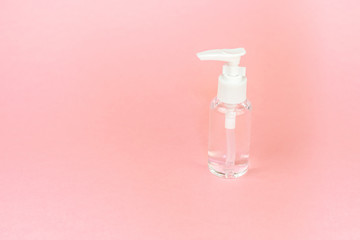 Beauty cosmetics glassbottle; branding mock up; front view on pastel pink background. Package for essential oil.