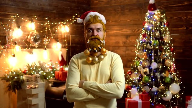 Thanksgiving day and Christmas. Expression and people concept - man with funny face over Christmas background. Christmas decorations. Christmas funny Santa. Santa fun. New year - party fun.