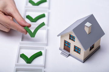 Check Mark Sign Near The House Model