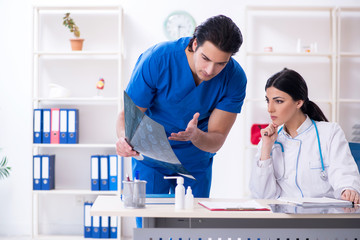 Two young doctors working in the clinic 