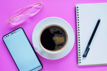 hand holding cup of coffee and laptop