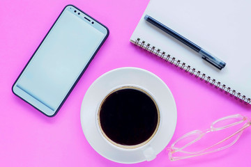 hand holding cup of coffee and laptop