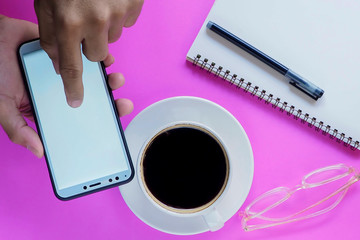 hand holding cup of coffee and laptop