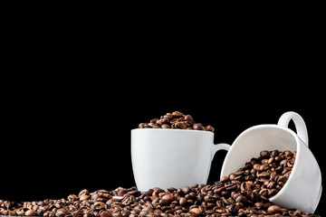 Black coffee in white cup and coffee beans on black background. Top view, space for text