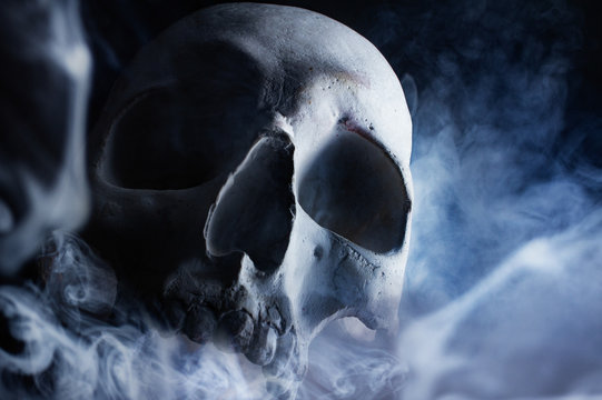 Human skull in smoke front view.