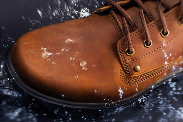 Brown leather suede boots water splashing.