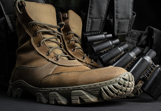 Photo of a pair of military boots with armor vest.