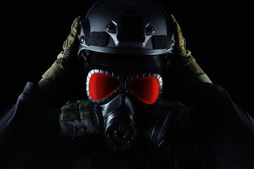 Warrior soldier in gas mask front view closeup.