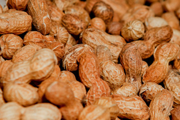 Peanuts in shell texture background. Raw peanuts on display at a farmer's market