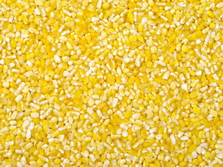 raw crushed corn groats close up