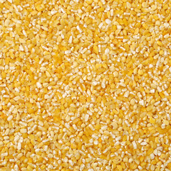 raw crushed corn groats close up