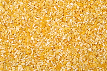 raw crushed corn groats close up