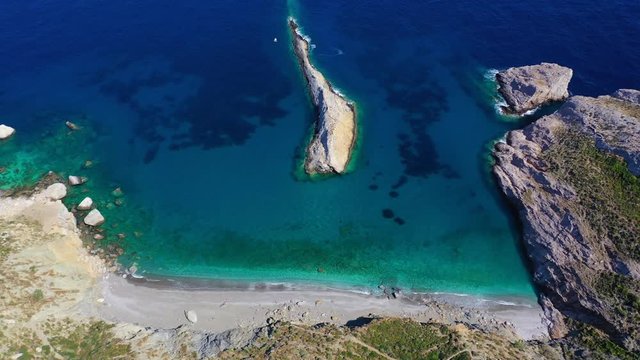 Aerial drone video of iconic deep turquoise beach of Katergo with crystal clear sea and sandy sea shore, Folegandros island, Cyclades, Greece