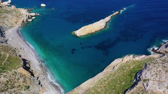 Aerial drone video of iconic deep turquoise beach of Katergo with crystal clear sea and sandy sea shore, Folegandros island, Cyclades, Greece