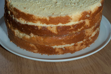 Making sponge cake. Isolated on wooden table. Homemade cake. Close-up. Side view.