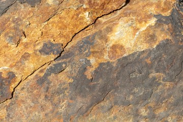 Rough cracked texture of old and weathered rock