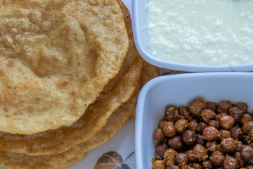 Kala Channa and Curd with Puri, Indian dish Or Black Chickpeas with fried bread. Selective focus.
