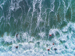Aerial view. People swimming at the sea. Sea water in emereald green color.