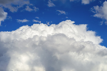 Naklejka na ściany i meble Big and fluffy cloud on the blue sky