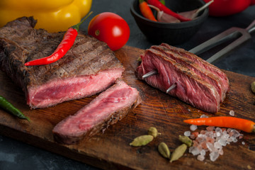 Fried beef steak on wooden board