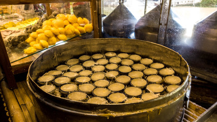 Merchant making Thai Toddy Palm cake in the market, Thai traditional dessert that made from toddy palm, rice flour and coconut milk.