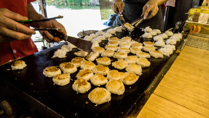 Merchant making Thai style desserts call "Kanom Bha Bin" or Coconut pancake