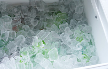 close up on drinking cans inside ice blocks in the cooler