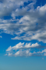 White clouds against a blue sky. Blue sky background with clouds.