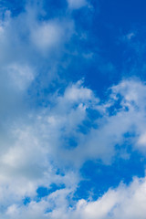 White clouds against a blue sky. Blue sky background with clouds.