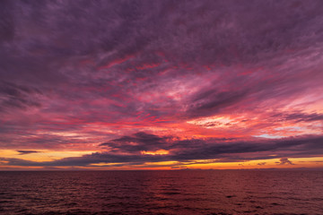 Colorful sunset sky. Fiery powerful sunset. Moody colorful sunset. Sunset over a lake.