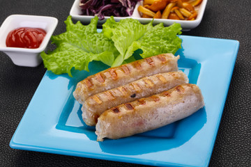 Grilled sausages served mushrooms and cabbage