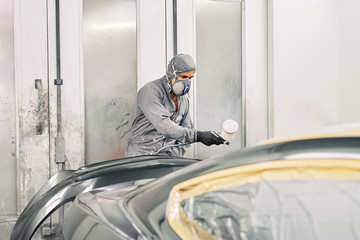 A man painting a car
