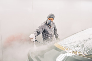 A man painting a car