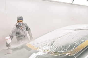 A man painting a car
