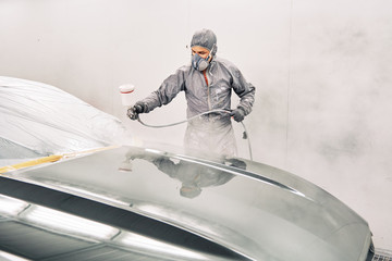 A man painting a car