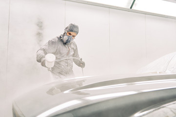 A man painting a car