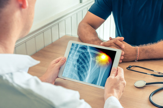 Doctor holding a digital tablet with x-ray of the chest of the patient. Pain on the shoulder
