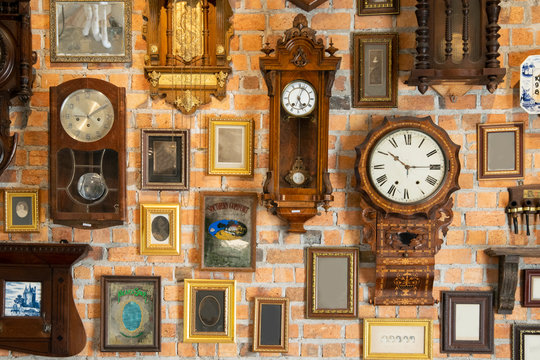 Collection of vintage clock hanging on an brick wall