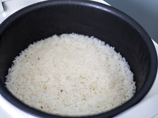 Steam rice in electronic cooker.
