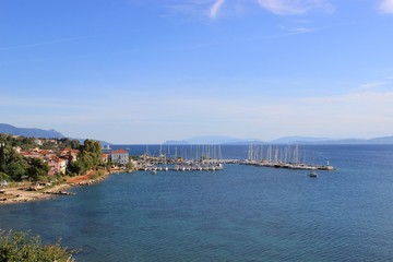 Fototapeta na wymiar Harbor of Palairos town in Aitolakarnania in Greece at summer. Background view sailing boats moored and tied at the small marina