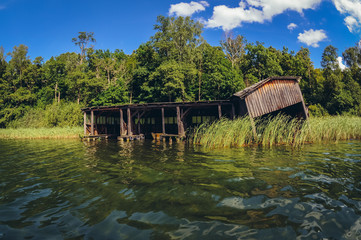 Old wooden haven on Lanskie Lake located in Olsztyn Lake District, near the village of Lansk in Warmian-Masurian Voivodeship of Poland