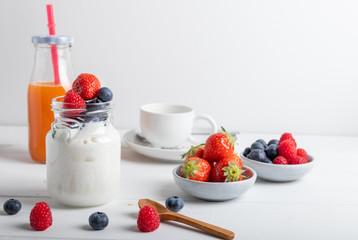 A serving of yogurt with fresh fruit on a breakfast table