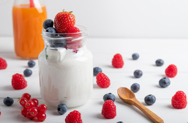 A serving of yogurt with fresh fruit on a breakfast table