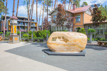 City Jurmala, Latvian Republic. Urban street view with tourists and big rock. Travel photo.2019....