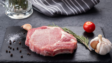 Raw pork chop steakt with spices. Space for text