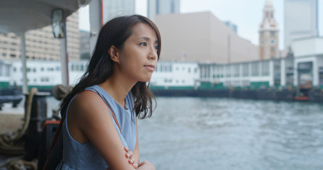 Asian Woman visit Hong Kong city and take the ferry