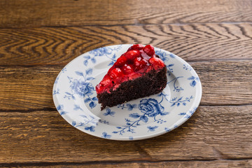 chocolate cake with strawberry jam isolated on wooden background